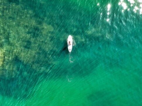 top view photo of person paddleboarding