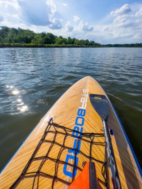 view from a paddle board on a lake